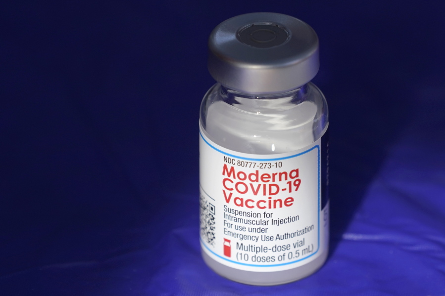 FILE - In this March 4, 2021 file photo, a vial of the Moderna COVID-19 vaccine rests on a table at a drive-up mass vaccination site in Puyallup, Wash., south of Seattle. Moderna's COVID-19 vaccine brought in more than $4 billion in second-quarter sales, Thursday, Aug. 5,  pushing the vaccine developer into a profit.  (AP Photo/Ted S.