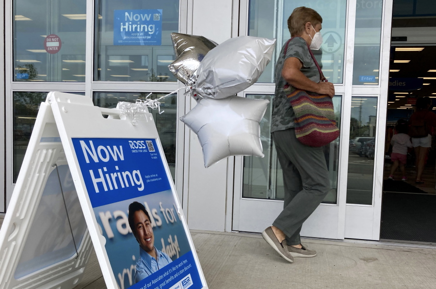 A shopper passes a hiring sign while entering a retail store in Morton Grove, Ill., Wednesday, July 21, 2021. Despite an uptick in COVID-19 cases and a shortage of available workers, the U.S. economy likely enjoyed a burst of job growth last month as it bounces back with surprising vigor from last year's coronavirus shutdown. The Labor Department's July jobs report Friday, Aug. 6 is expected to show that the United States added more than 860,000 jobs in July, topping June's 850,000, according to a survey of economists by the data firm FactSet.   (AP Photo/Nam Y.