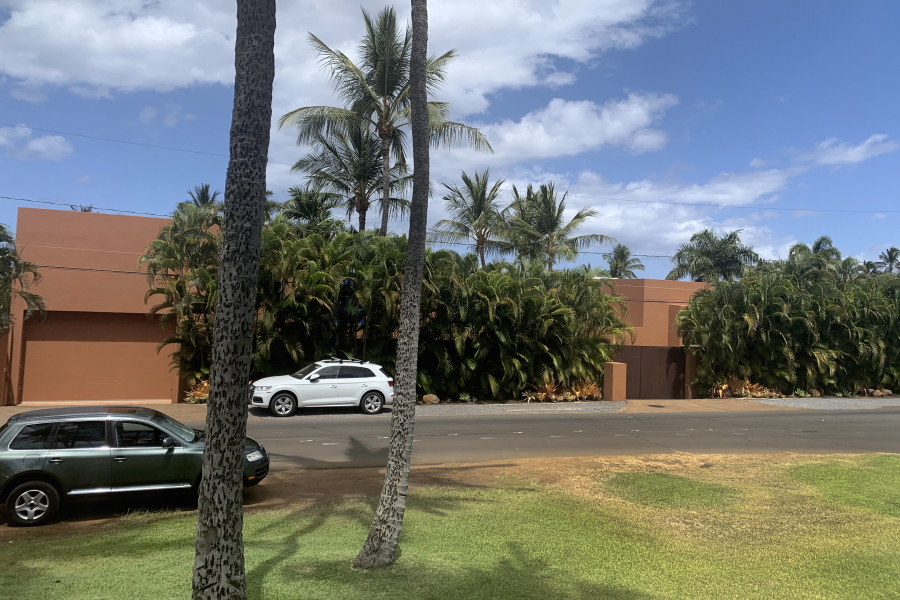 Part of a Maui mansion is seen from a street in Kihei, Hawaii on Thursday, Aug. 5, 2021. The $45-million cash sale of the eight-bedroom house reflects a hot real estate market where the median price of a Maui home topped $1.1 million in June. (J.D.