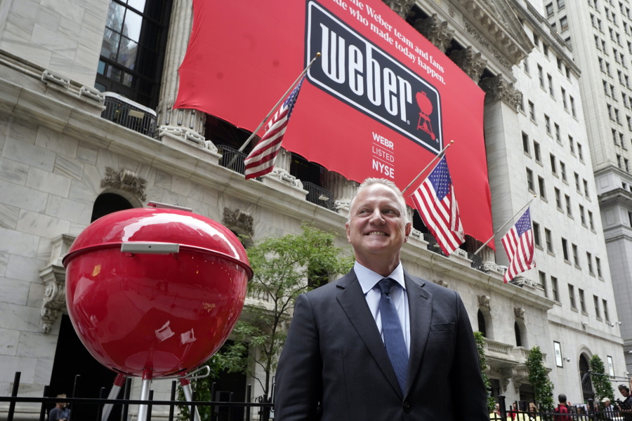 Weber Inc. CEO Chris Scherzinger poses beside a giant grill outside the New York Stock Exchange prior to his company's IPO, Thursday, Aug. 5, 2021.
