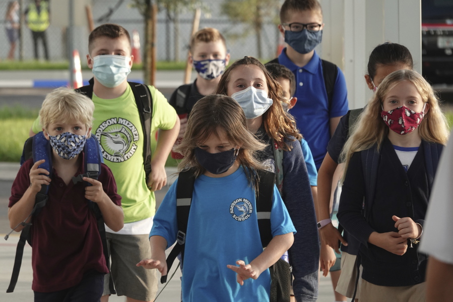 Students arrive to on the firs day to the newly-rebuilt Addison Mizner School in Boca Raton, Tuesday, Aug. 10, 2021. Palm Beach County Schools opened the school year with a masking requirement with an opt-out option.
