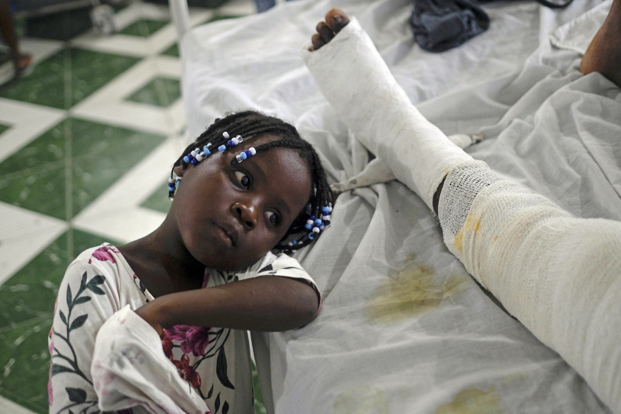 Younaika rests next to her mother, Jertha Ylet, on Sunday at the hospital in Les Cayes, Haiti. The 7.2 magnitude quake brought down their house in Camp-Perrin.
