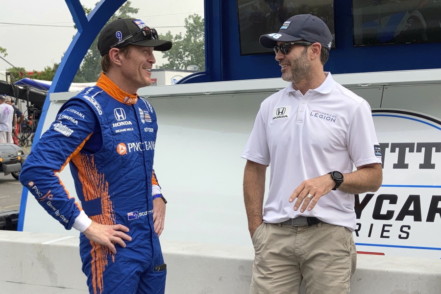 Scott Dixon, left, chats with Chip Ganassi Racing teammate Jimmie Johnson before the start of practice Friday in Nashville, Tenn.