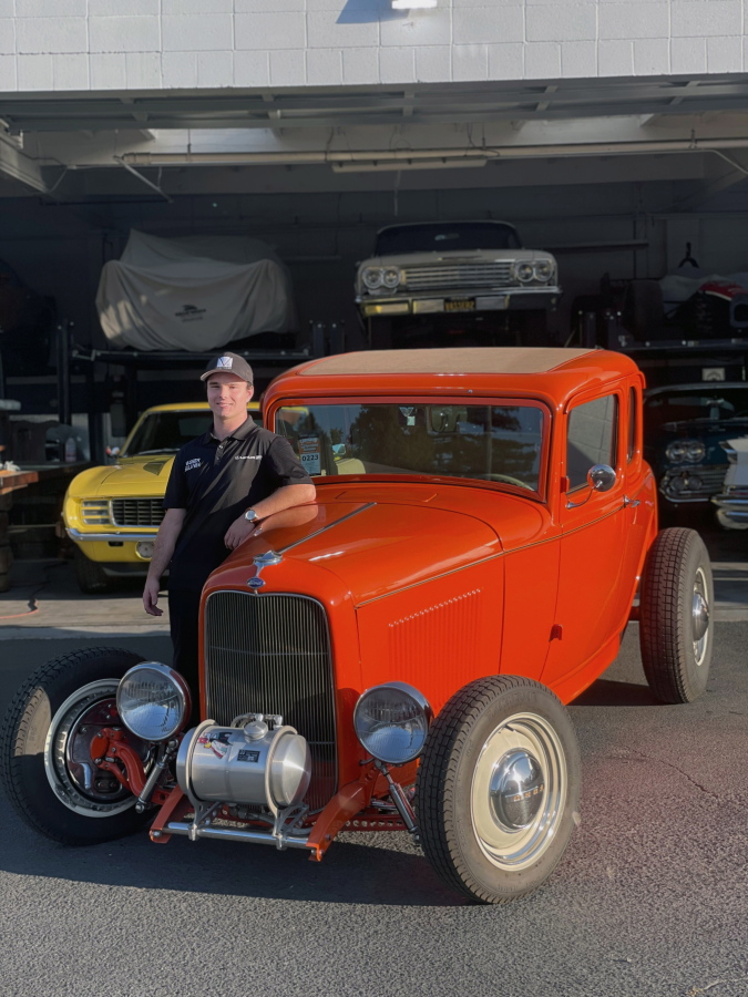 Cole Kleis standing next to a 1932 Ford Coup in front of a garage of old cars he's been restoring with his family in Napa, Calif. Automakers are facing a challenge with the newest generation of drivers -- teens of today aren't in a hurry to get their first car let alone a drivers license.
