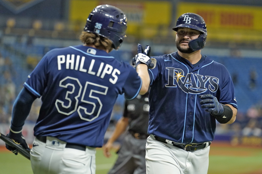 The Rays' Mike Zunino, right, celebrates with Brett Phillips after his solo home run off Seattle's Drew Steckenrider.
