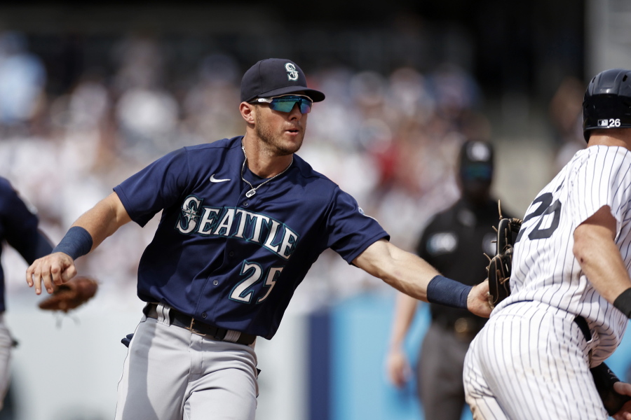 Seattle Mariners shortstop Dylan Moore (25) tags out New York Yankees' DJ LeMahieu during the sixth inning of a baseball game on Saturday, Aug. 7, 2021, in New York.