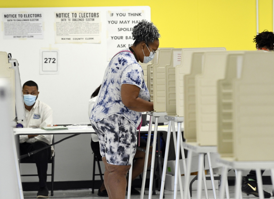 Jennifer Johnson, 61, of Detroit, votes at the Detroit Service Learning Academy in the state's primary election, Tuesday morning, Aug. 3, 2021, in Detroit.