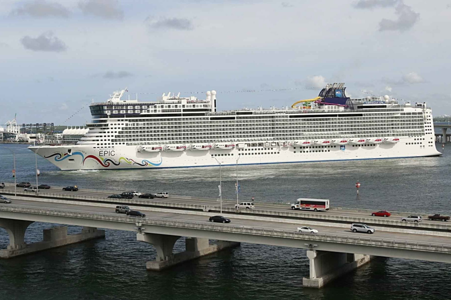 FILE - In this July 7, 2010, file photo, the Norwegian Epic, owned by the Norwegian Cruise Line Corporation, sails through the Government Cut to the Port of Miami in Miami. A federal judge on Sunday night, Aug. 8, 2021, granted Norwegian Cruise Line's request to temporarily block a Florida law banning cruise companies from asking passengers for proof of coronavirus vaccination before they board a ship. U.S. District Judge Kathleen Williams granted the preliminary injunction in a lawsuit challenging the state's "vaccine passport" ban, which was signed into law in May by Republican Gov. Ron DeSantis.