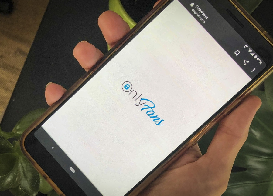 FILE - This photo shows a phone app for OnlyFans, a site where fans pay creators for their photos and videos, Thursday Aug. 19, 2021. OnlyFans says it has "suspended" a plan to ban sexually explicit content following an outcry from its creators and advocates for sex workers. The company tweeted Wednesday, Aug.