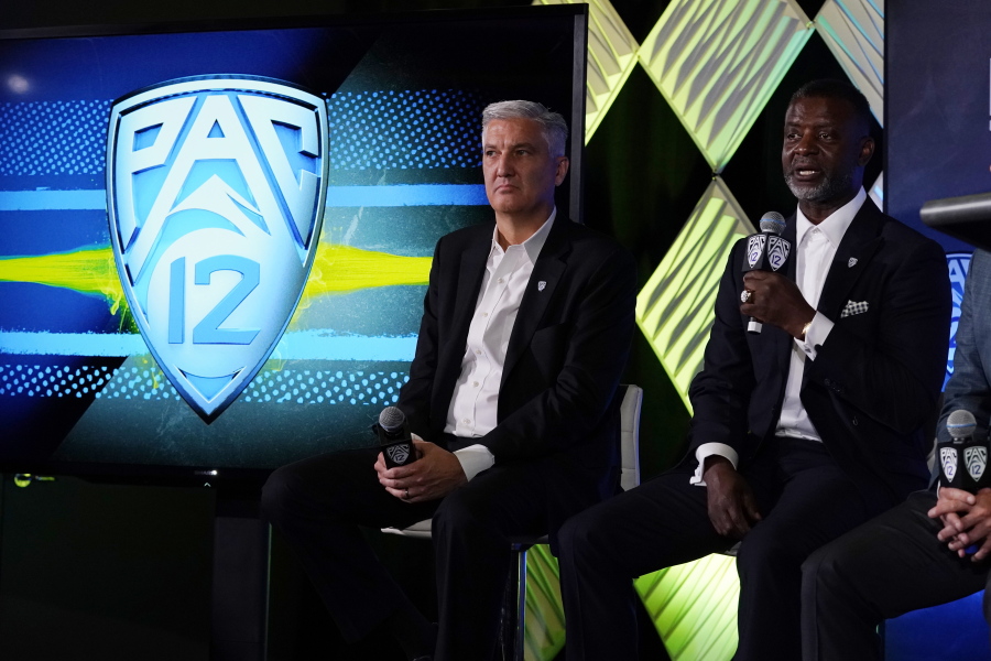 Pac-12 Commissioner George Kliavkoff, center, and Senior Associate Commissioner for Football Operations Merton Hanks field questions during the Pac-12 Conference NCAA college football Media Day Tuesday, July 27, 2021, in Los Angeles.