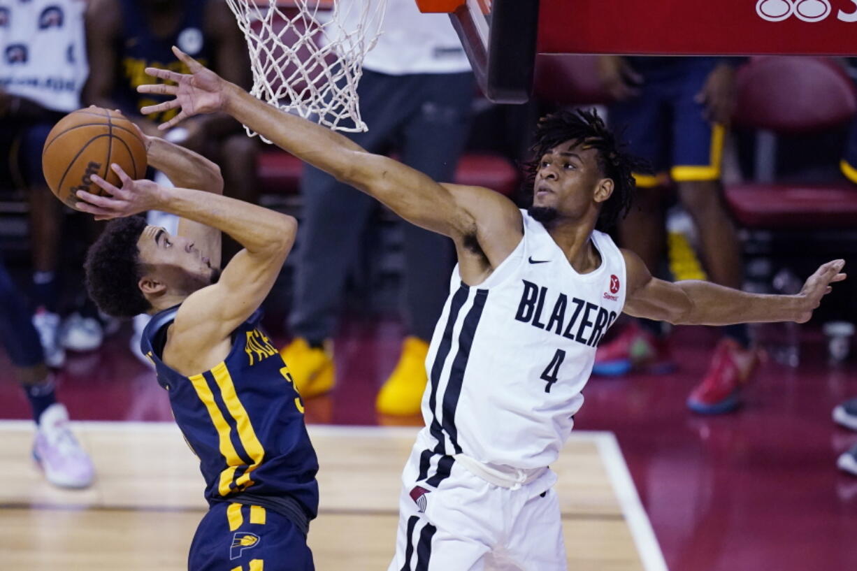 Portland Trail Blazers' Greg Brown III, right, fouls Indiana Pacers' Chris Duarte during the first half of an NBA summer league basketball game Thursday, Aug. 12, 2021, in Las Vegas.