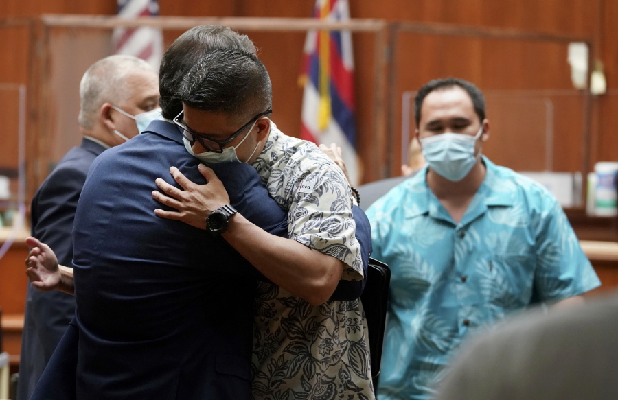 Honolulu Police officer Geoffrey Thom hugs a supporter after Judge William Domingo rejected murder and attempted murder charges against Thom and two fellow officers in the fatal shooting of a teenager, preventing the case from going to trial, Wednesday, Aug. 18, 2021, at district court in Honolulu.