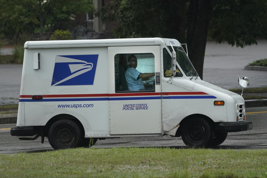 U.S. Postal Service carrier John Graham drives a 28-year-old delivery truck while making's rounds, Wednesday, July 14, 2021, in Portland, Maine. Hundreds of the aging trucks were reported to catch fire in recent years. (AP Photo/Robert F.