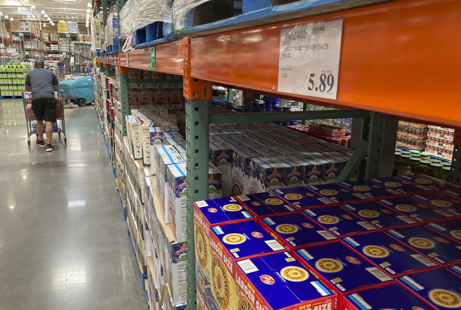 A shopper guides a cart past a line of gigantic boxes of breakfast cereals in a Costco warehouse on Thursday, June 17, 2021, in Lone Tree, Colo. Inflation at the wholesale level jumped 1% in June, pushing price gains over the past 12 months up by a record 7.3%. The Labor Department reported Wednesday, July 14 that the June increase in its producer price index, which measures inflation pressures before they reach consumers, followed a gain of 0.8% in May and was the largest one-month increase since January.