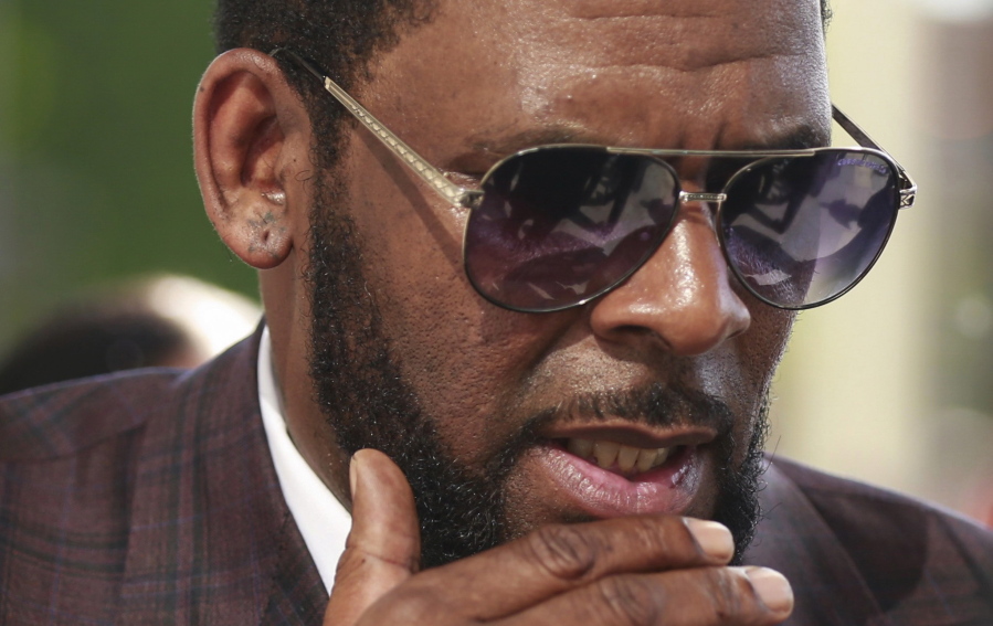 FILE - This photo from Wednesday June 26, 2019, shows R&B singer R. Kelly arriving at the Leighton Criminal Court in Chicago for arraignment on sex-related charges. Federal prosecutors in New York on Friday, July 23, 2021 asked a judge for permission to admit more evidence for which Kelly has not been charged, at his upcoming sex-trafficking trial in Brooklyn.