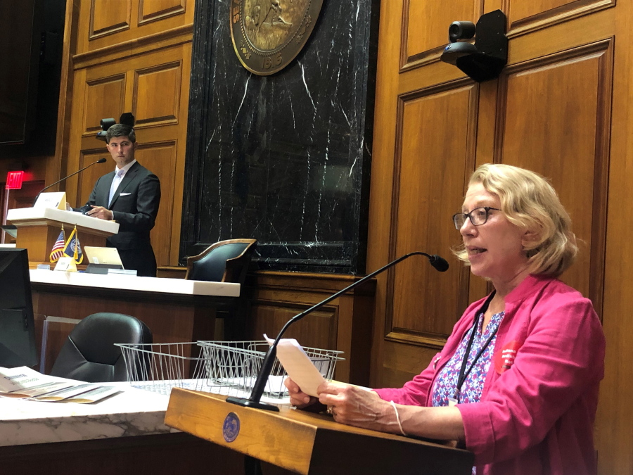 Julia Vaughn, executive director of Common Cause Indiana, speaks during a legislative redistricting hearing as Republican Rep. Tim Wesco, chairman of the Indiana House Elections Committee, looks on at the Indiana Statehouse in Indianapolis on Aug. 11, 2021.