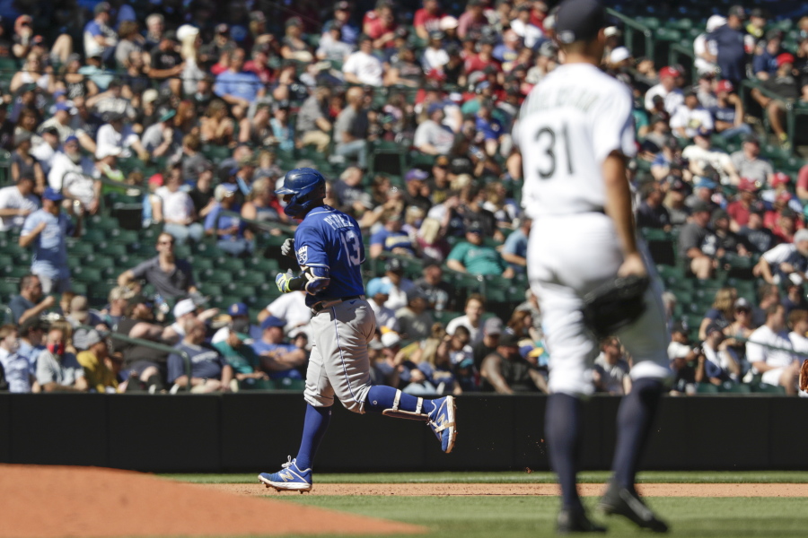 Kansas City Royals' Salvador Perez rounds third after hitting a two-run home run as Seattle Mariners starting pitcher Tyler Anderson looks on during the fifth inning of a baseball game Saturday, Aug. 28, 2021, in Seattle.