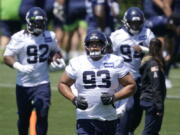 FILE - In this June 16, 2021, file photo, Seattle Seahawks' Al Woods (93) runs between drills during NFL football practice in Renton, Wash. Woods always intended to continue his NFL career, even when he decided to join the small pool of players who opted out of the 2020 season due to the COVID-19 pandemic. (AP Photo/Ted S.