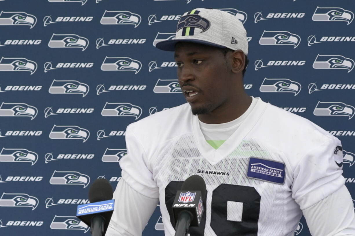 Seattle Seahawks defensive end Aldon Smith talks to reporters after NFL football practice Saturday, July 31, 2021, in Renton, Wash. (AP Photo/Ted S.
