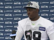 Seattle Seahawks defensive end Aldon Smith talks to reporters after NFL football practice Saturday, July 31, 2021, in Renton, Wash. (AP Photo/Ted S.