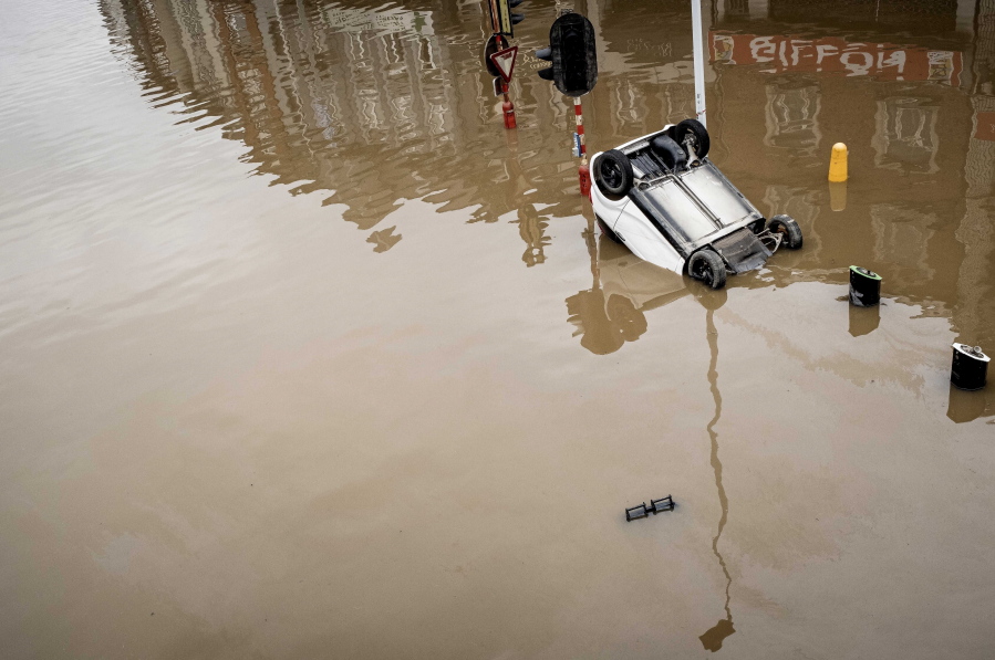 A car sits submerged after flooding July 16 in Chenee, Belgium. This summer, a lot of the places hit by disasters are not used to getting weather extremes.