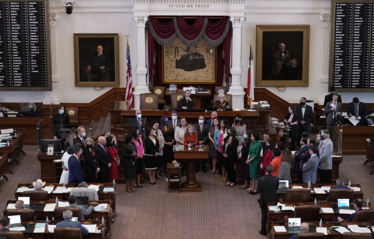 FILE - In this May 5, 2021, file photo, Texas state Rep. Donna Howard, D-Austin, center at lectern, stands with fellow lawmakers in the House Chamber in Austin, Texas, as she opposes a bill introduced that would ban abortions as early as six weeks and allow private citizens to enforce it through civil lawsuits, under a measure given preliminary approval by the Republican-dominated House. Abortion providers in Texas are asking the Supreme Court to prevent enforcement of a state law that would allow private citizens to sue anyone for helping a woman get an abortion after about six weeks of pregnancy.