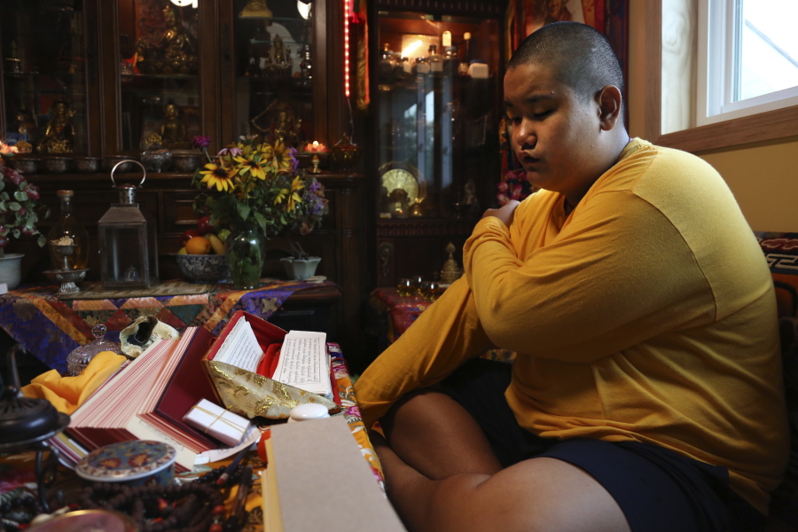 Jalue Dorje, 14, says his morning prayers July 20 in Columbia Heights, Minn.