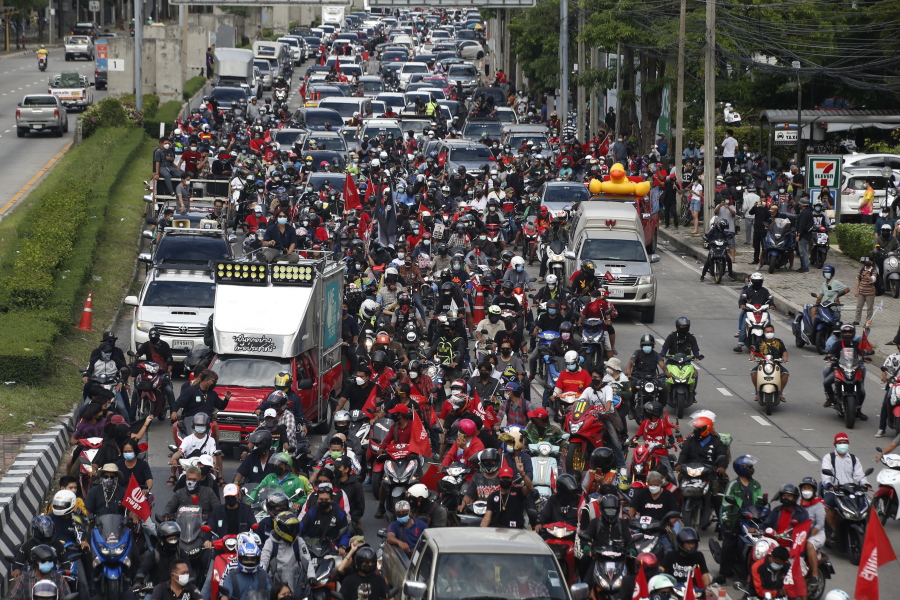 Anti-government protesters block the road with cars and motorcycles as a part of their "car mob" demonstrations along several roads in Bangkok, Thailand, Sunday, Aug. 29, 2021. A long line of cars, trucks and motorbikes wended its way Sunday through the Thai capital Bangkok in a mobile protest against the government of Prime Minister Prayuth Chan-ocha. The protesters on wheels hope their nonviolent action, dubbed a "car mob," can help force the ouster of Prayuth, whom they accuse of botching the campaign against the coronavirus.