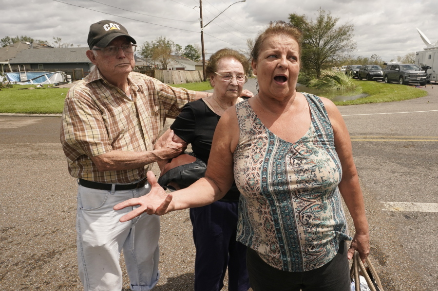 Residents of the Spring Meadow subdivision, Debbie Greco, and her parents Fred Carmouche, and his wife Faye, talk to the media after being helped out of their flood ed home on a boat after Hurricane Ida moved through Monday, Aug. 30, 2021, in LaPlace, La.