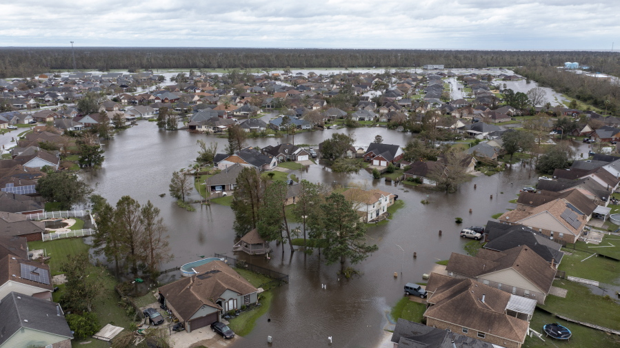 Flooded streets and homes are shown in the Spring Meadow subdivision in LaPlace, La., after Hurricane Ida moved through Monday, Aug. 30, 2021. Hard-hit LaPlace is squeezed between the Mississippi River and Lake Pontchartrain.