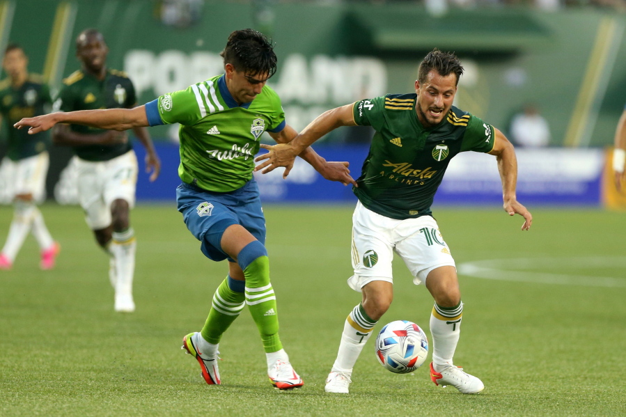 Timbers midfielder Sebastian Blanco, right, navigates around a Sounders defender during the Sounders' 6-2 win.