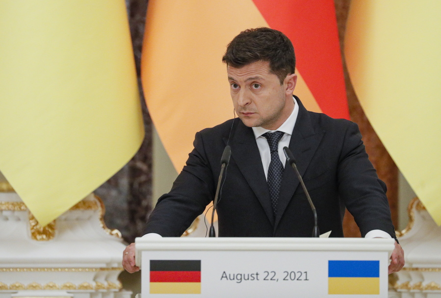 Ukrainian President Ukrainian President Volodymyr Zelenskyy attends a joint news conference with German Chancellor Angela Merkel following their talks at the Mariinsky palace in Kyiv, Ukraine, Sunday, Aug. 22, 2021. German Chancellor Angela Merkel arrived to Kyiv for a working visit to meet with top Ukrainian officials.