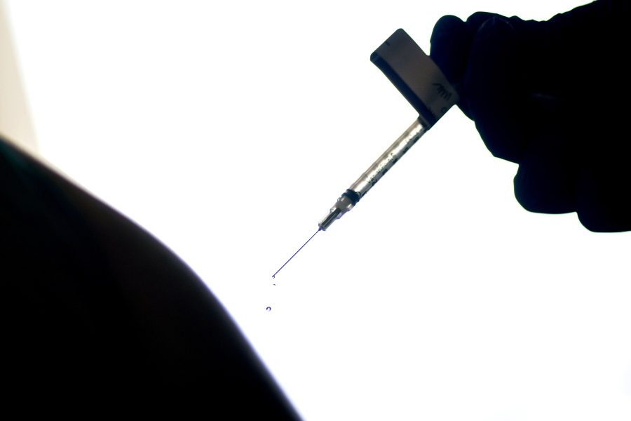 A droplet falls from a syringe after a health care worker was injected with a COVID-19 vaccine at a hospital in Providence, R.I., in 2020.