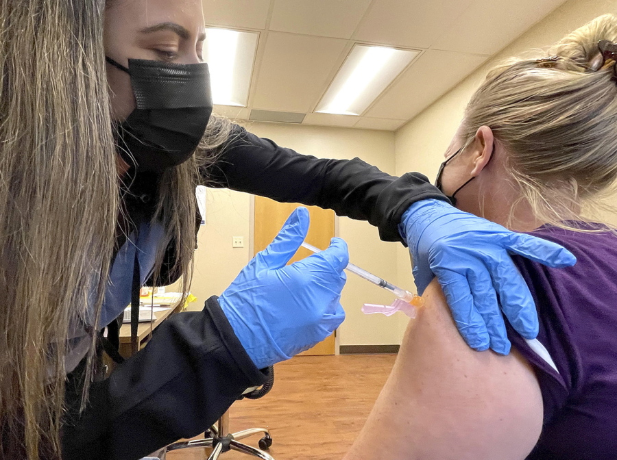 nurse Jennifer Ulloa administers a COVID-19 vaccine Tuesday, July 27, 2021, at the County's vaccination clinic in Whispering Pines, Calif.