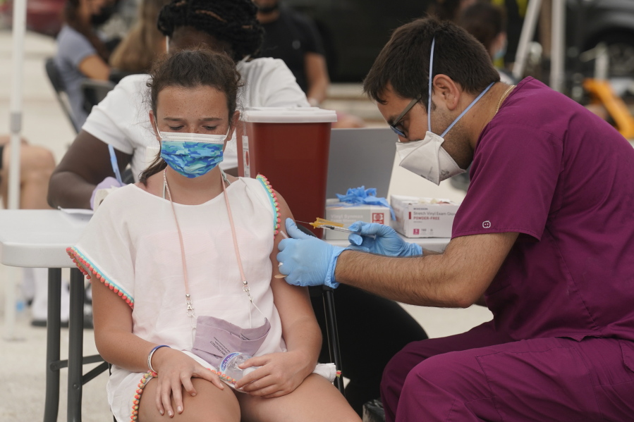Francesca Anacleto, 12, receives her first Pfizer COVID-19 vaccine shot from nurse Jorge Tase, Wednesday, Aug. 4, 2021, in Miami Beach, Fla. On Tuesday, the CDC added more than 50,000 new COVID-19 cases in the state over the previous three days, pushing the seven-day average to one the highest counts since the pandemic began, an eightfold increase since July 4.