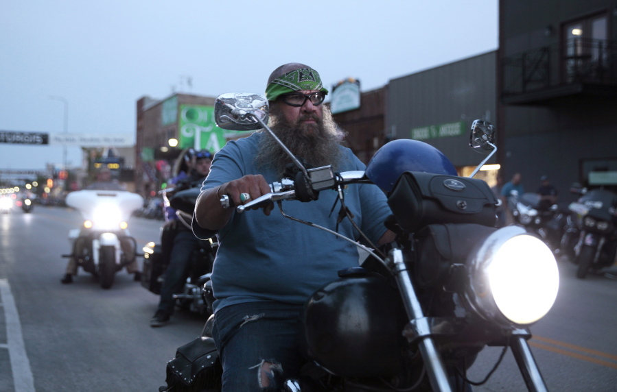 Motorcycles cruised through downtown Sturgis, S.D., on Thursday, Aug. 5, 2021. The Sturgis Motorcycle Rally starts Friday, even as coronavirus cases rise in South Dakota.