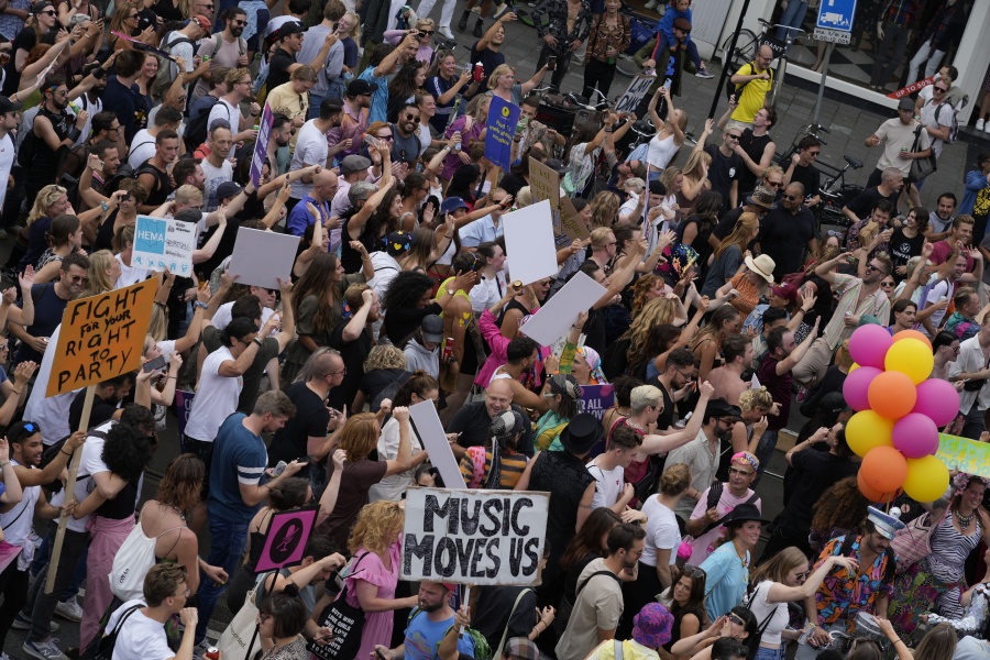 Thousands of fans of music festivals stage protests in Amsterdam, Netherlands, Saturday, Aug. 21, 2021, against the government's COVID-19 restrictions on large-scale outdoor events.