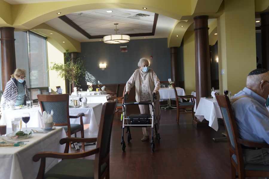FILE - In this April 1, 2021, file photo May Nast arrives for dinner at RiverWalk, an independent senior housing facility, in New York.