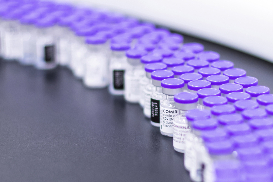 In this March 2021 photo provided by Pfizer, vials of the Pfizer-BioNTech COVID-19 vaccine are prepared for packaging at the company's facility in Puurs, Belgium. On Wednesday, Aug. 25, 2021, the company said it started the application process for U.S. approval of a booster dose of its two-shot COVID-19 vaccine  for people ages 16 and older.