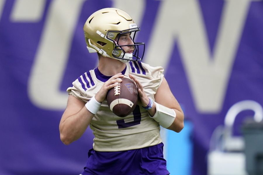 FILE - Washington Huskies quarterback Dylan Morris looks to pass during NCAA college football practice in Seattle, in this Friday, Aug. 6, 2021, file photo. Washington begins the 2021 season as one of the favorites in the Pac-12 North Division, while also trying to erase the bad taste of how last year ended when a COVID-19 outbreak brought a sudden end to an already truncated schedule.