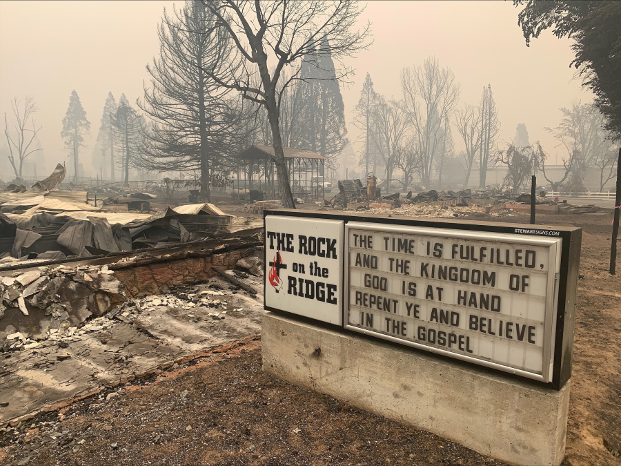 A sign for The Rock on the Ridge Church is seen in Greenville, Calif., after the Dixie Wildfires Thursday, Aug. 12, 2021. California's largest single wildfire in recorded history is running through forestlands as fire crews try to protect rural communities from flames that have destroyed hundreds of homes. The Dixie Fire is the largest single fire in California history and the largest currently burning in the U.S. It is about half the size of the August Complex, a series of lightning-caused 2020 fires across seven counties that were fought together and that state officials consider California's largest wildfire overall.