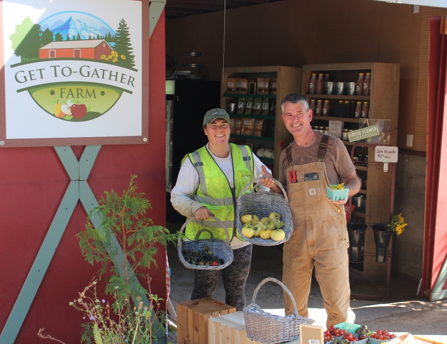 Andra and John Spencer show a recent harvest of fruit from their Washougal Get To-Gather retail farm stand.