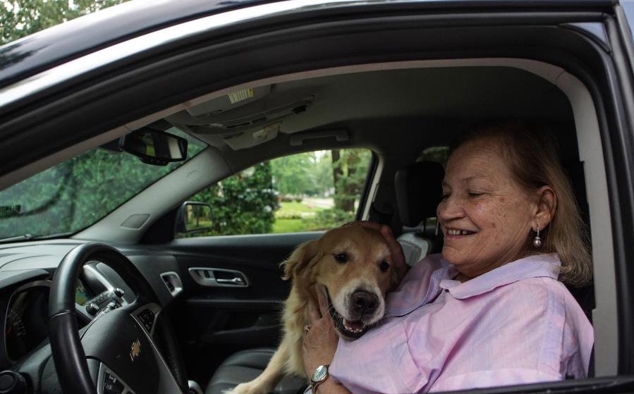 Margie Bauer of Harper Woods, Mich., cuddles her dog Liberty inside her 2015 Chevy Equinox on Aug. 22. Bauer bought the vehicle because two dogs could easily fit in the back seat.
