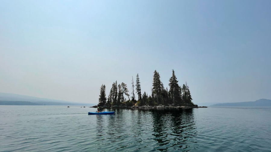 A small island on the north end of Waldo Lake is one of the few things clearly visible on the smoky afternoon of August 15, 2021.