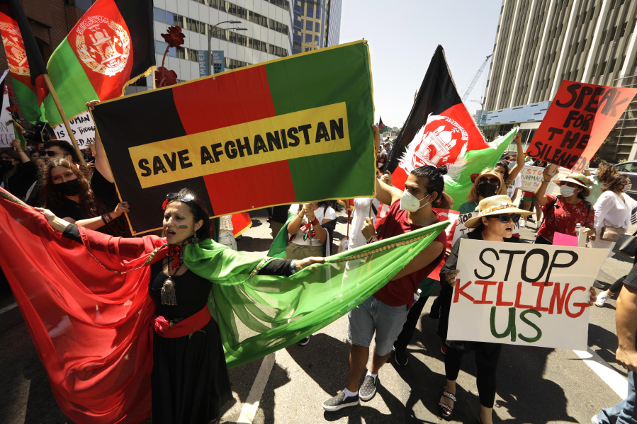 Hundreds of Afghan-Americans and others protest and march down Wilshire Boulevard in support of Afghanistan and the hope that President Joe Biden will step-up efforts to evacuate Afghans and to send humanitarian aid to the country on August 28, 2021.