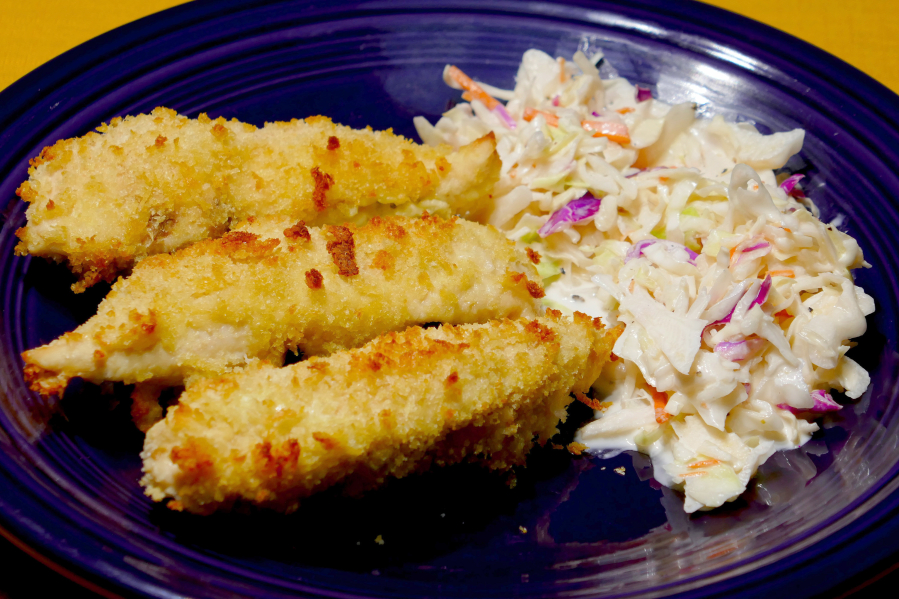 Oven-fried chicken tenders with coleslaw.