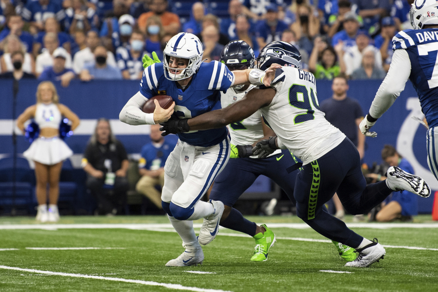 Indianapolis Colts quarterback Carson Wentz (2) scrambles from pressure by Seattle Seahawks defensive end Rasheem Green (94) during the season opener on Sunday, Sept. 12, 2021, in Indianapolis. Green had perhaps his best day as a pro with four tackles, a sack and two pass breakups.