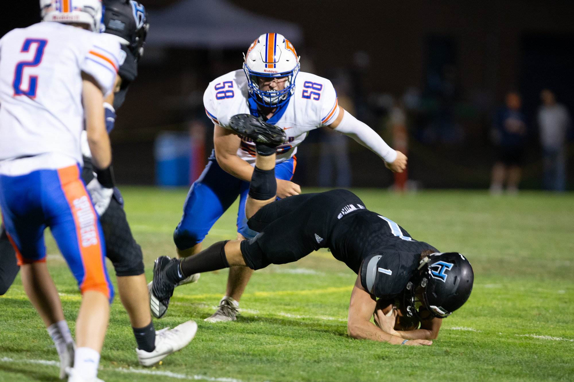 Hockinson Hawks Andre Northrup (1) is thrown to the ground in a tackle by Ridgefield Spudders Wyatt Bartroff (58) in the 2A Greater St. Helens League season opener for both teams at Hockinson High School on Friday, Sept. 17, 2021. (Randy L.