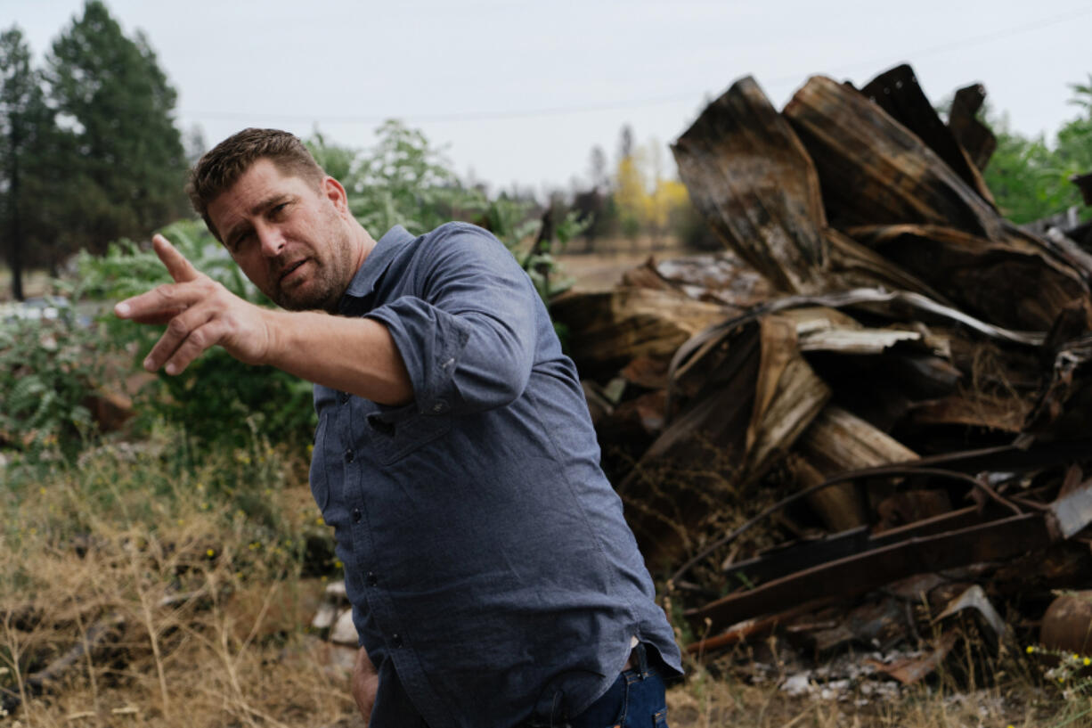 Scott Hokonson, Director of Long Term Recovery in Malden, Wash., points out remaining damage and debris left in the town. The high cost of cleanup and removal of debris has played a large part in the delay of rebuilding.