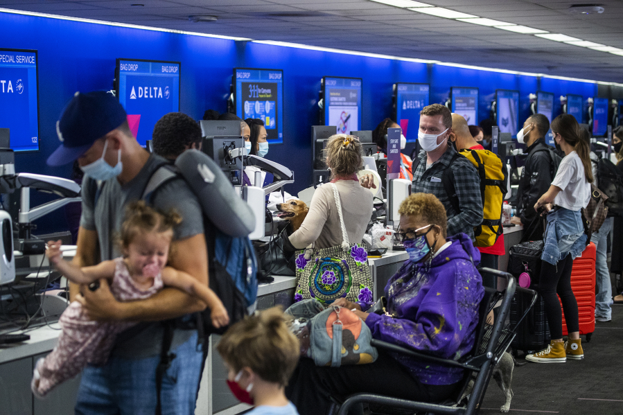 Amid a busy getaway travel day for the Memorial Day weekend and the first holiday since coronavirus pandemic restrictions have been relaxed, a crowd of travelers check in for their flights at Los Angeles International Airport at Delta Airlines, Terminal 2 at LAX on May 28, 2021. (Allen J.